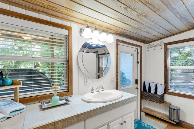 a bedroom with furniture and a large window