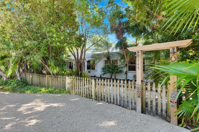 a view of a house with a small yard and plants