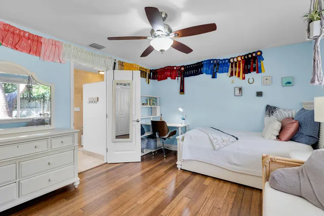 a bed room with a bed and ceiling fan
