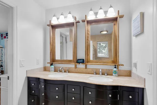 a living room with patio furniture and a potted plant