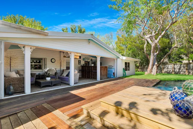 a view of a house with swimming pool and sitting area