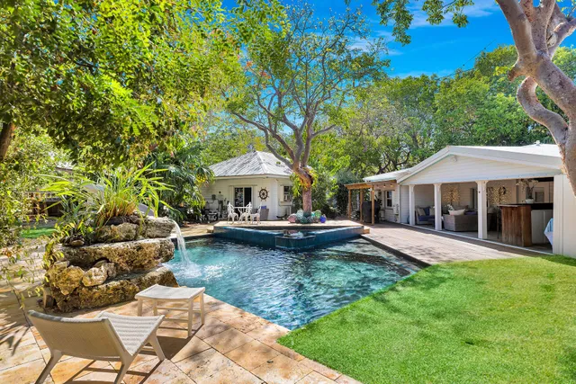 a view of yard with swimming pool and sitting area