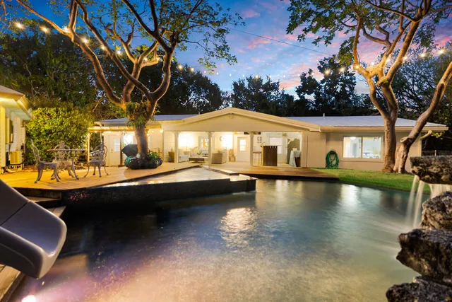 a view of a terrace with lawn chairs and wooden fence