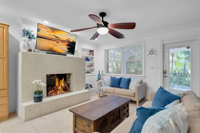 a view of a dining room with furniture and a chandelier fan