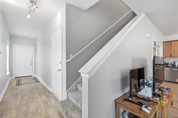 a view of a hallway with workspace and a living room