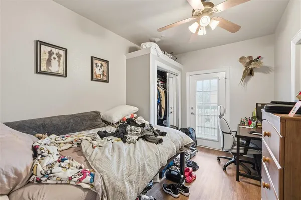 a bed sitting in a bedroom next to a window and a chandelier