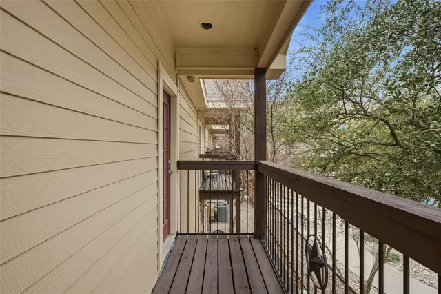 a view of a balcony with wooden floor
