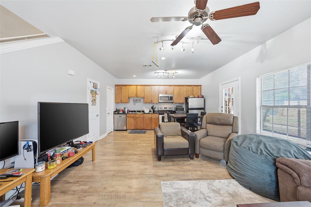 2410 South 2nd Street, Unit 737 Waco, TX 76706 - Photo 6 of 40 living room to kitchen and half bathroom downstairs off living room