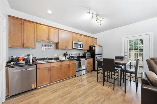 a kitchen with granite countertop a sink counter top space appliances and cabinets