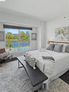 a bedroom with a bed a couch and a window
