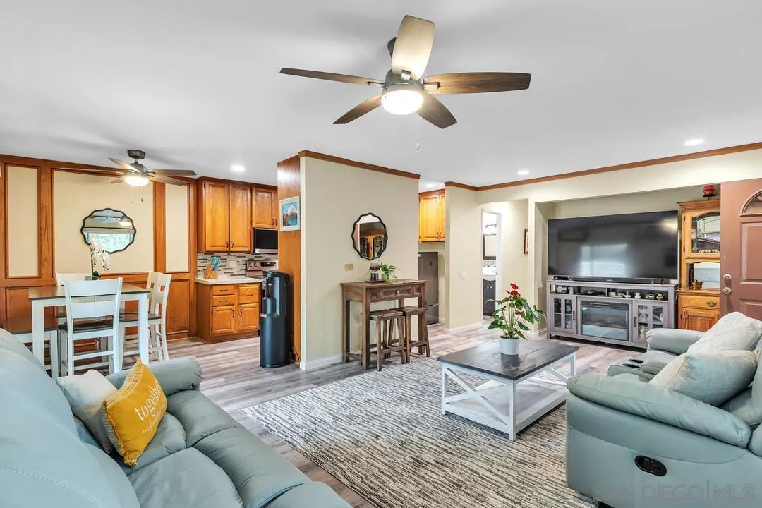 8683 Wahl Street Santee, CA 92071 - Photo 1 of 24 a living room with furniture kitchen view and a large window