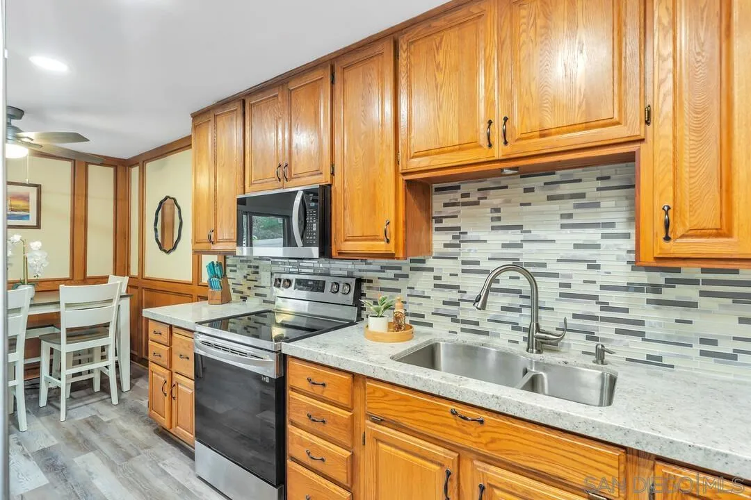 8683 Wahl Street Santee, CA 92071 - Photo 11 of 24 a kitchen with stainless steel appliances a sink stove and cabinets