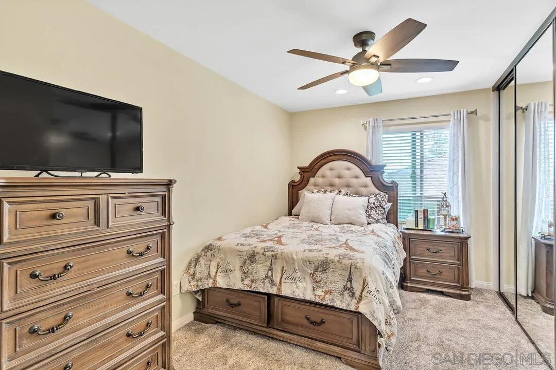 8683 Wahl Street Santee, CA 92071 - Photo 12 of 24 a bedroom with a bed and a flat screen tv