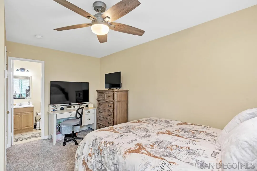 8683 Wahl Street Santee, CA 92071 - Photo 13 of 24 a bedroom with a bed and a flat tv screen on dresser