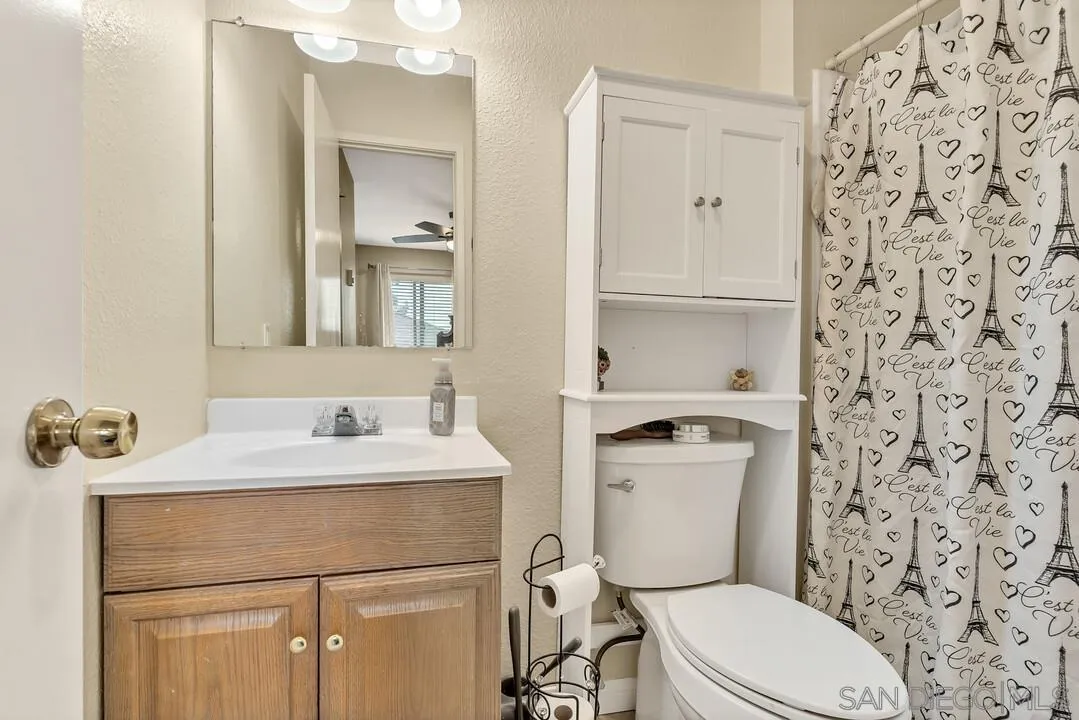 8683 Wahl Street Santee, CA 92071 - Photo 14 of 24 a bathroom with a sink a toilet and shower