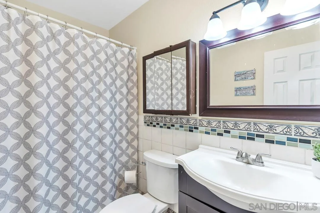 8683 Wahl Street Santee, CA 92071 - Photo 16 of 24 a bathroom with a sink and a mirror
