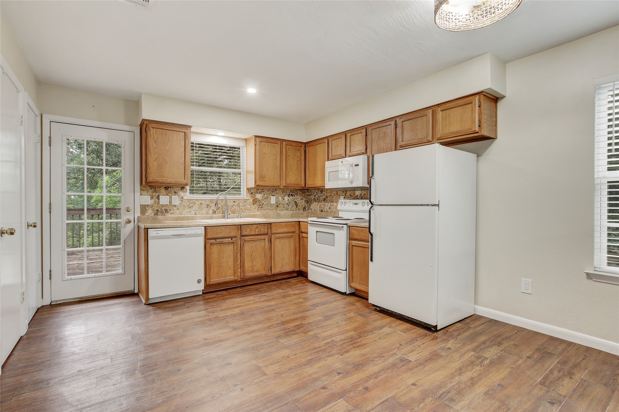 6902 Rifle Bend, Unit B Austin, TX 78736 - Photo 6 of 34 a kitchen with stainless steel appliances a refrigerator sink and cabinets