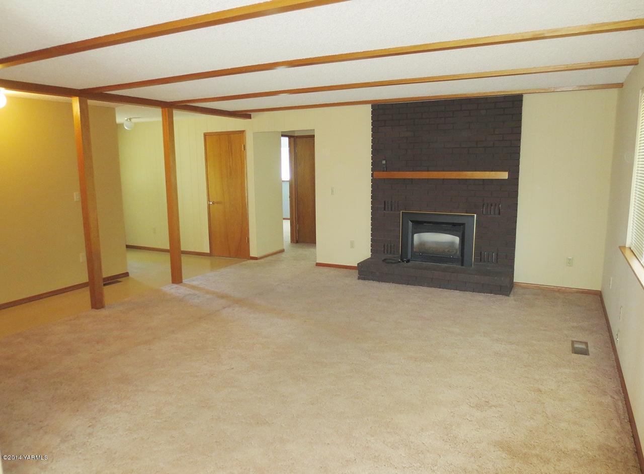 172 Kail Road Tieton, WA 98947 - Photo 5 of 16 a view of an empty room with a fireplace and a window