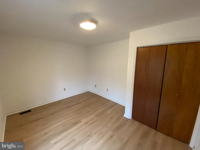 an empty room with wooden floor