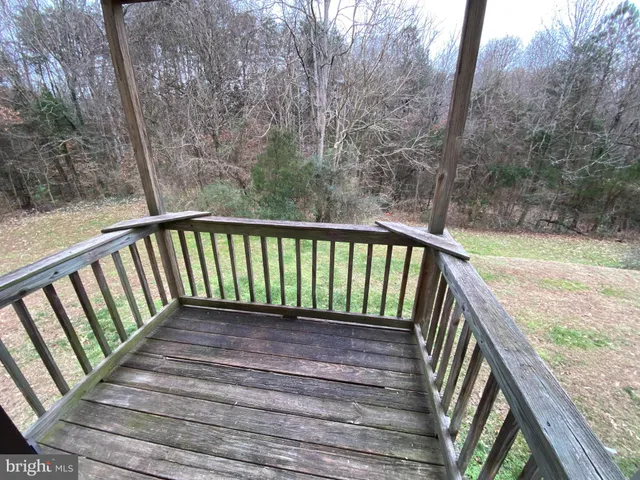 a view of a balcony with wooden floor