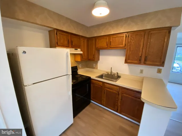 a white refrigerator freezer sitting inside of a kitchen