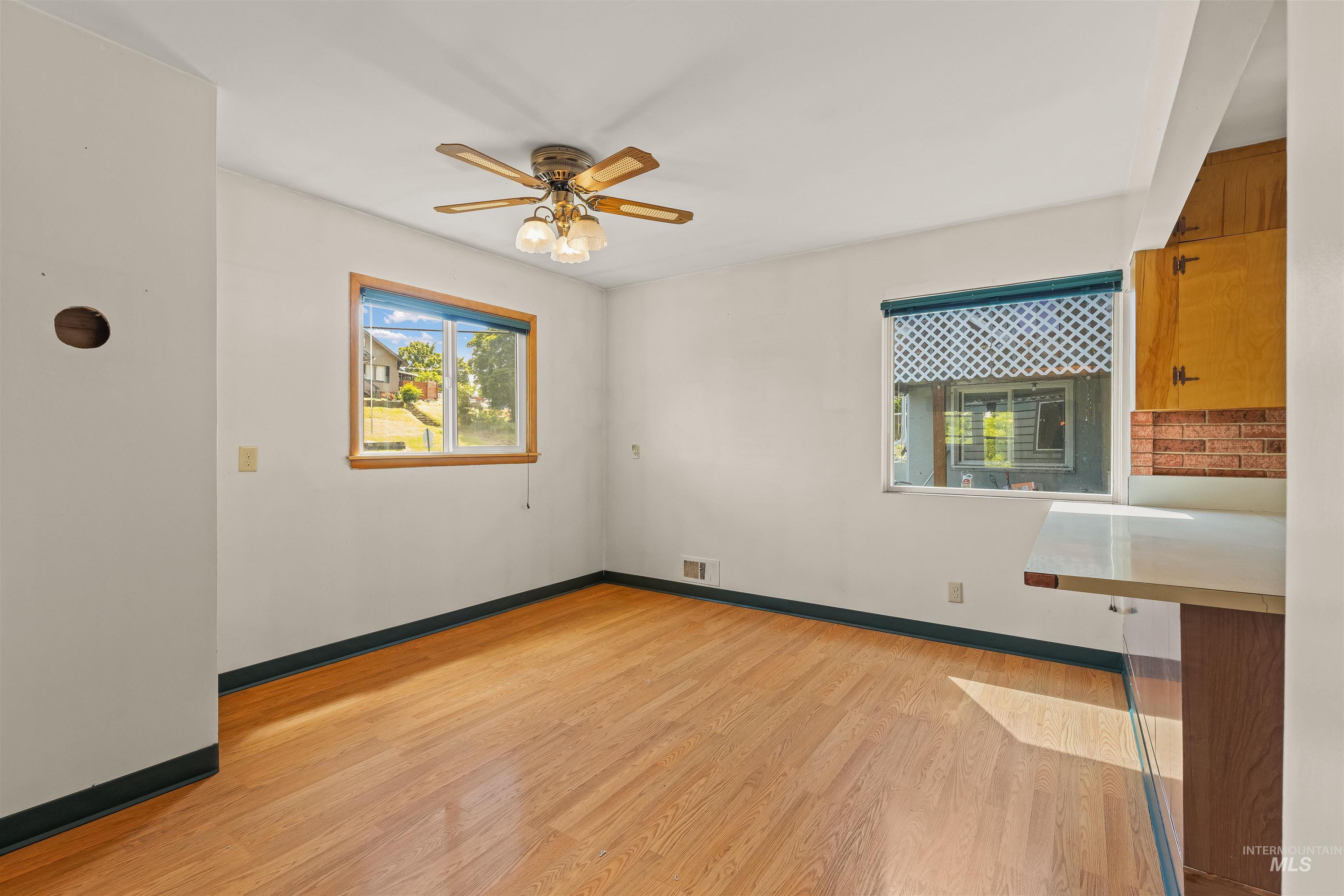 1663 9th Avenue Lewiston, ID 83501 - Photo 8 of 36 Room featuring wood-finish flooring, white walls, and dark baseboards