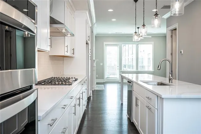 an empty room with ceiling fan and window