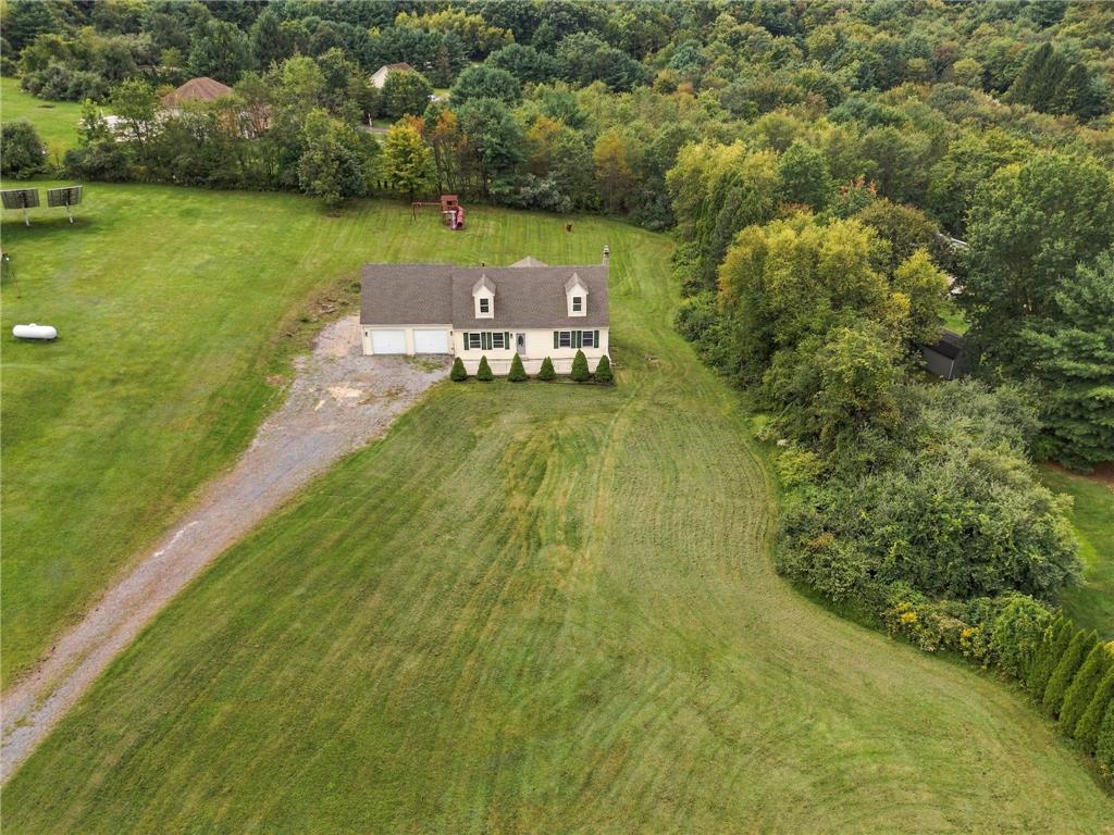 90 Gun Club Road Palmerton, PA 18071 - Photo 9 of 58 An aerial view showcases a Cape Cod home nestled against a dense forest border.