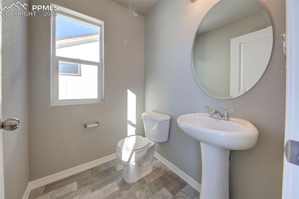 2951 Magic Carpet Loop Colorado Springs, CO 80916 - Photo 8 of 13 a bathroom with a sink a mirror and a toilet