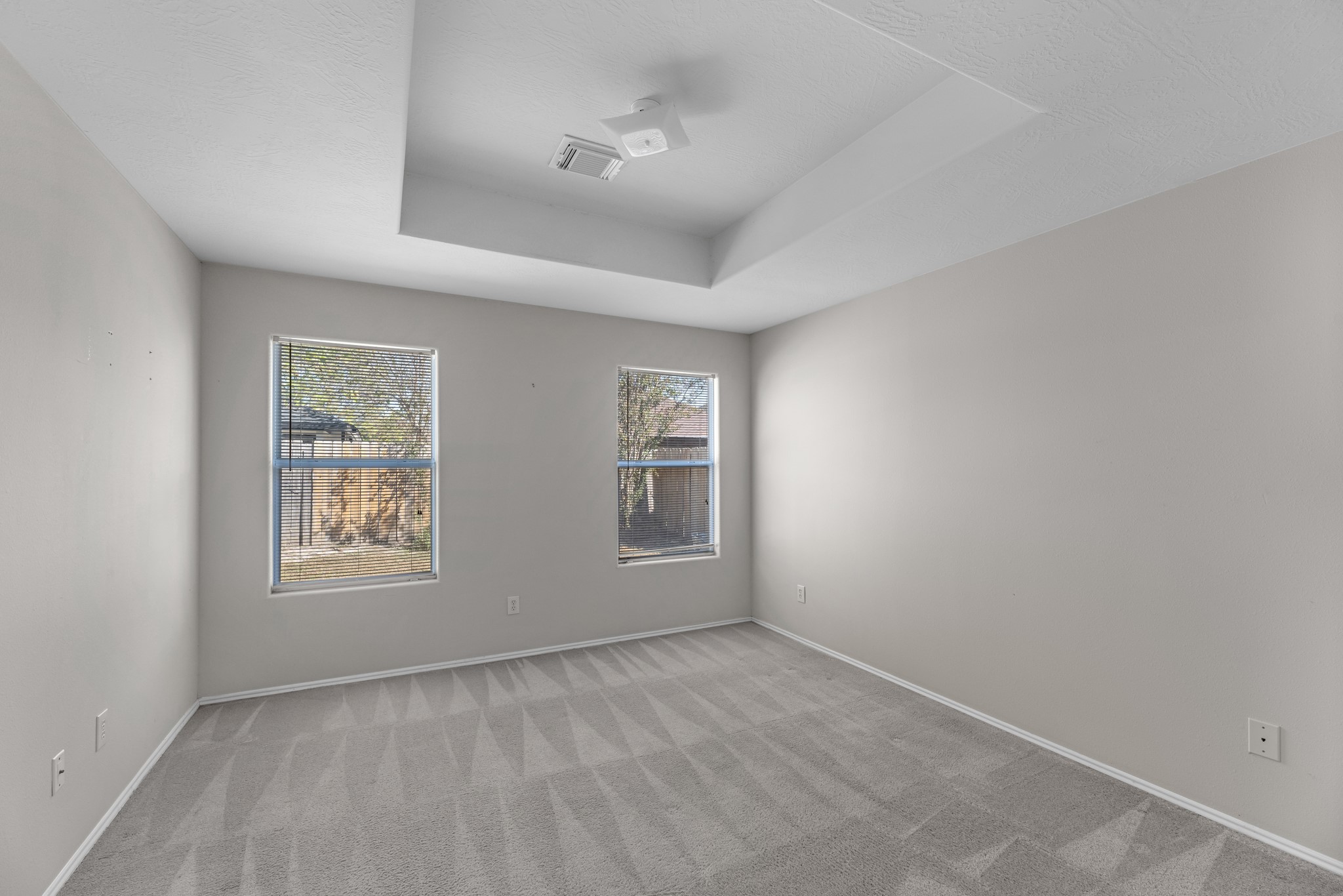 16810 Perryton Lane Houston, TX 77073 - Photo 15 of 26 The primary bedroom features neutral carpet and tray ceilings