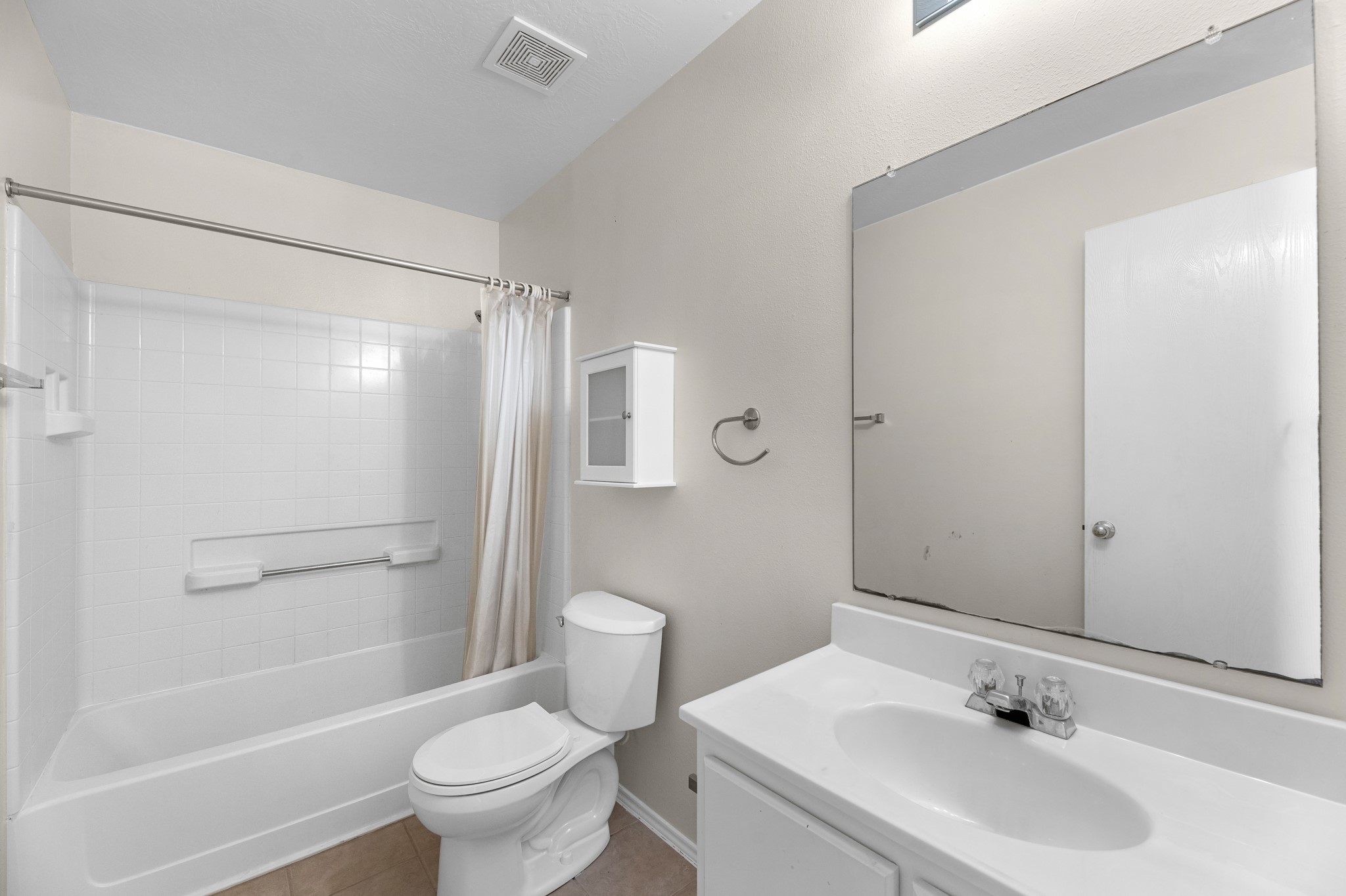 16810 Perryton Lane Houston, TX 77073 - Photo 21 of 26 The guest bath has a shower tub combo and tile flooring