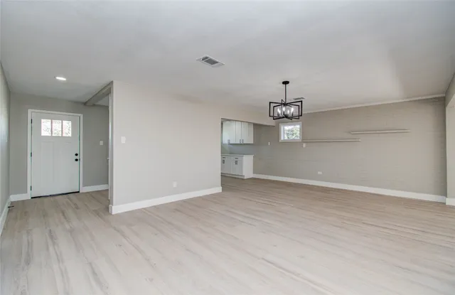 a view of a kitchen with wooden floor and a ceiling fan