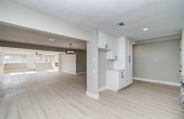 a view of a kitchen with a stove cabinets and wooden floor