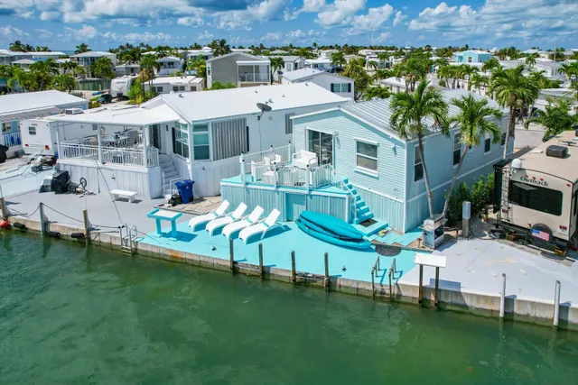 an aerial view of a house with swimming pool garden and bench