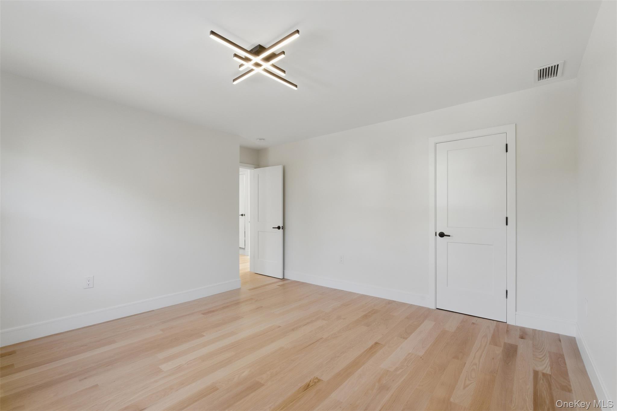 40 Calhoun Avenue New Rochelle, NY 10801 - Photo 21 of 49 Bright interior space featuring light wood-finish flooring, crisp white walls, and a contemporary ceiling light fixture