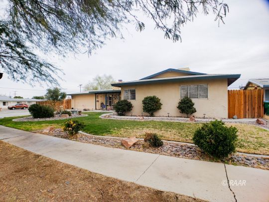 256 North Norma Street Ridgecrest, CA 93555 - Photo 3 of 35 a front view of a house with garden