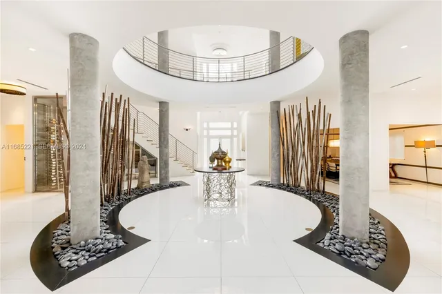 a view of hall way with furniture and chandelier