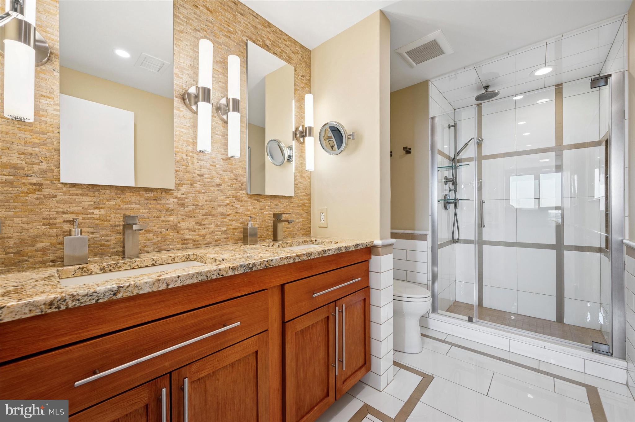 717 South Christopher Columbus Boulevard, Unit 802 Philadelphia, PA 19147 - Photo 18 of 32 a bathroom with a shower sink and mirror