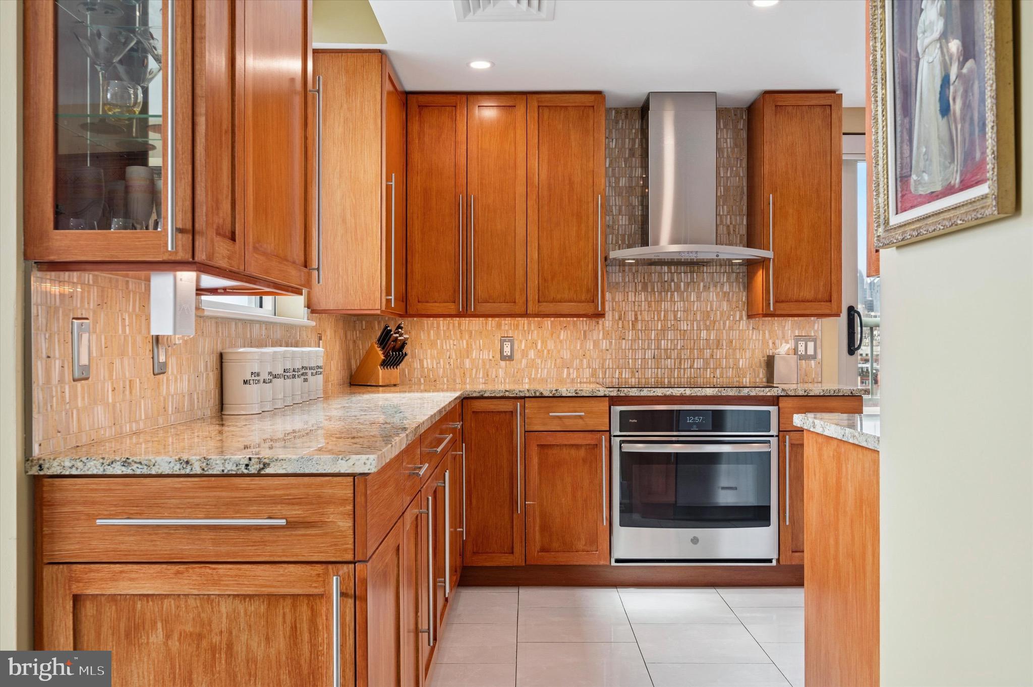 717 South Christopher Columbus Boulevard, Unit 802 Philadelphia, PA 19147 - Photo 9 of 32 a kitchen with stainless steel appliances granite countertop a stove and a microwave