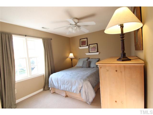 12108 North Exeter Way Raleigh, NC 27613 - Photo 11 of 19 a bedroom with a bed and a lamp