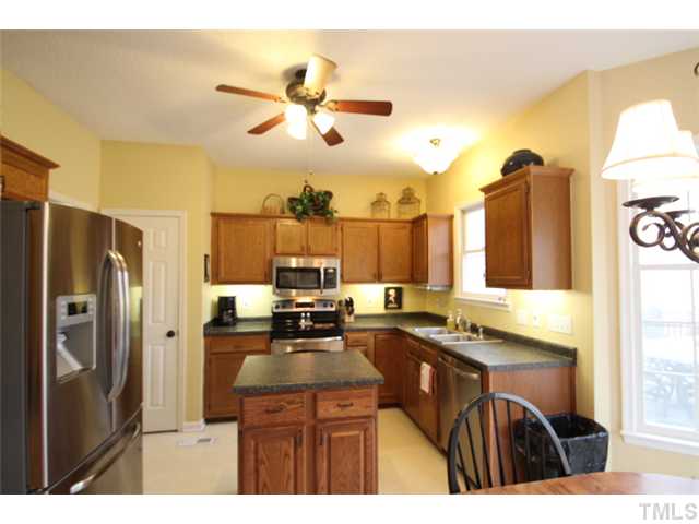 12108 North Exeter Way Raleigh, NC 27613 - Photo 3 of 19 a kitchen with a sink appliances and cabinets