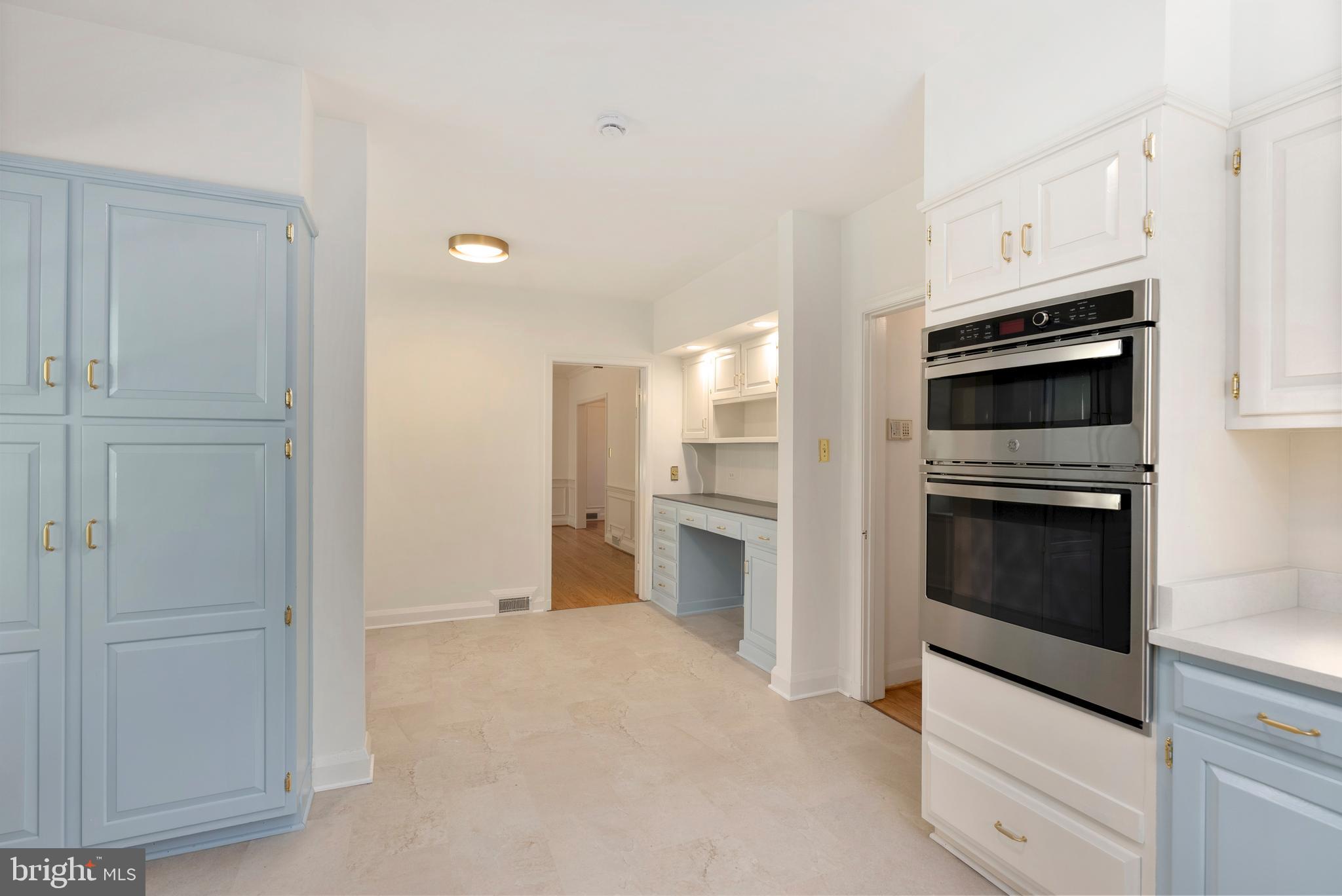 602 Stoneleigh Road Baltimore, MD 21212 - Photo 10 of 31 a kitchen with white cabinets and stainless steel appliances