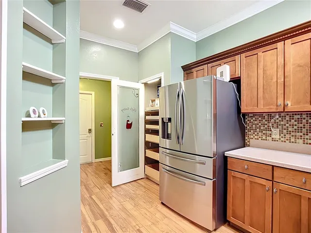 a kitchen with stainless steel appliances granite countertop a refrigerator and a sink