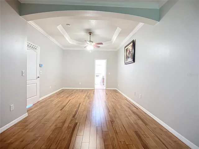 a view of empty room with wooden floor