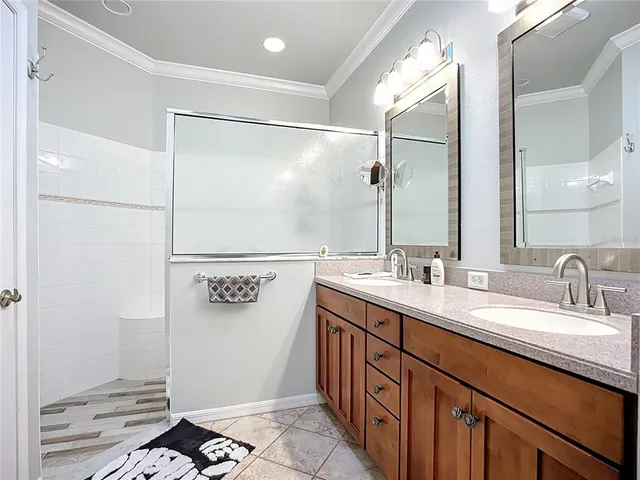 a bathroom with a double vanity sink and mirror