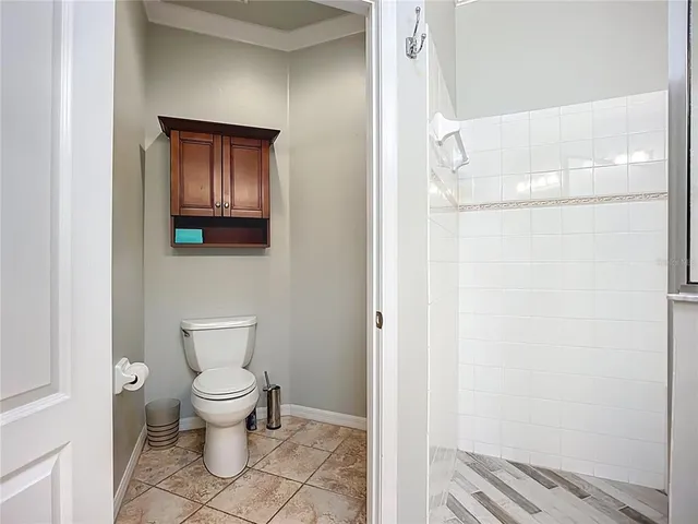 a bathroom with a toilet and a mirror