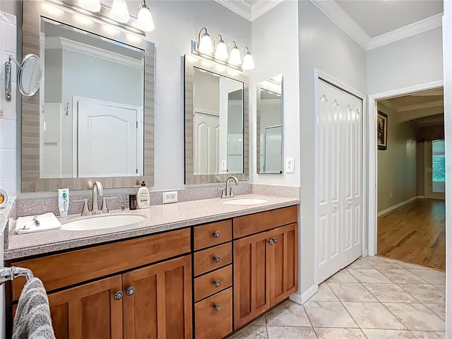 a bathroom with a double vanity sink and a mirror