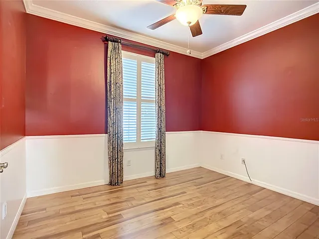 a view of empty room with wooden floor