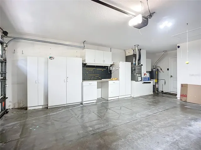 a view of a kitchen with a refrigerator and a stove top oven