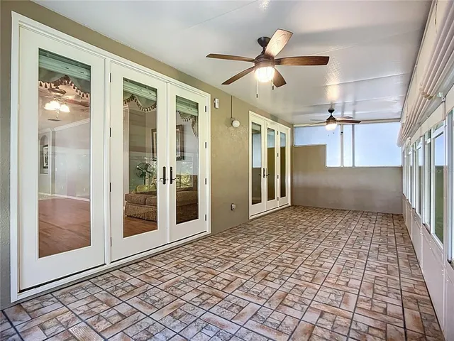 an empty room with entrance and windows